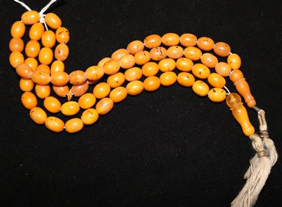 Two single strand amber bead necklaces,